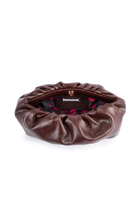 Brown leather clutch bag with a visible brand label on a white background