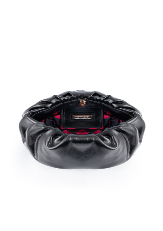 Black leather clutch with red lips interior on a white background